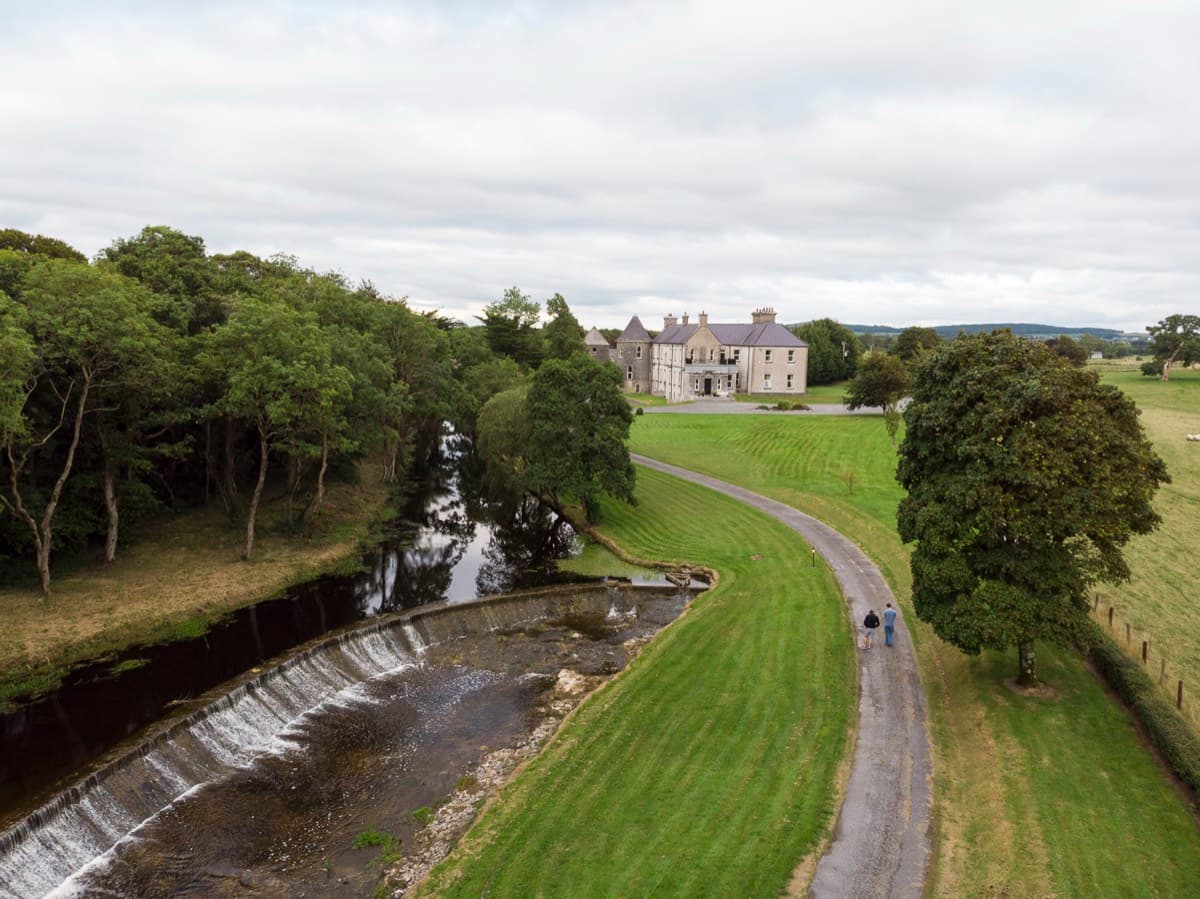 Aerial view of house, river and driveway